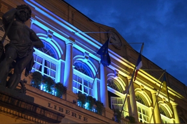 bâtiment illuminé en bleu et en jaune
