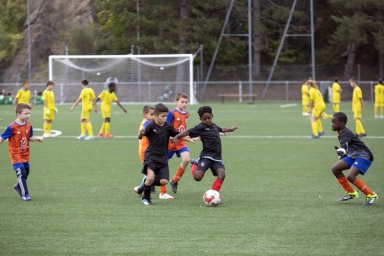 Des enfants jouant au foot sur un terrain rénové