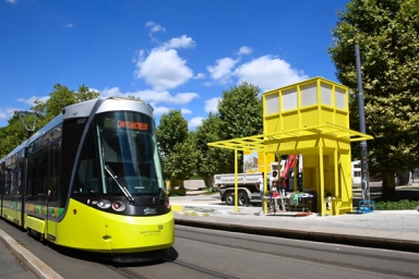 Un tram et une station de couleur jaune