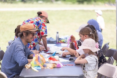 groupe d'adultes et d'enfants qui participent à un atelier scientifique