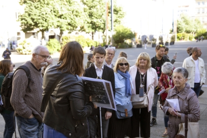 un groupe écoute une femme qui présente des photo du centre-ville - Agrandir l'image, fenêtre modale